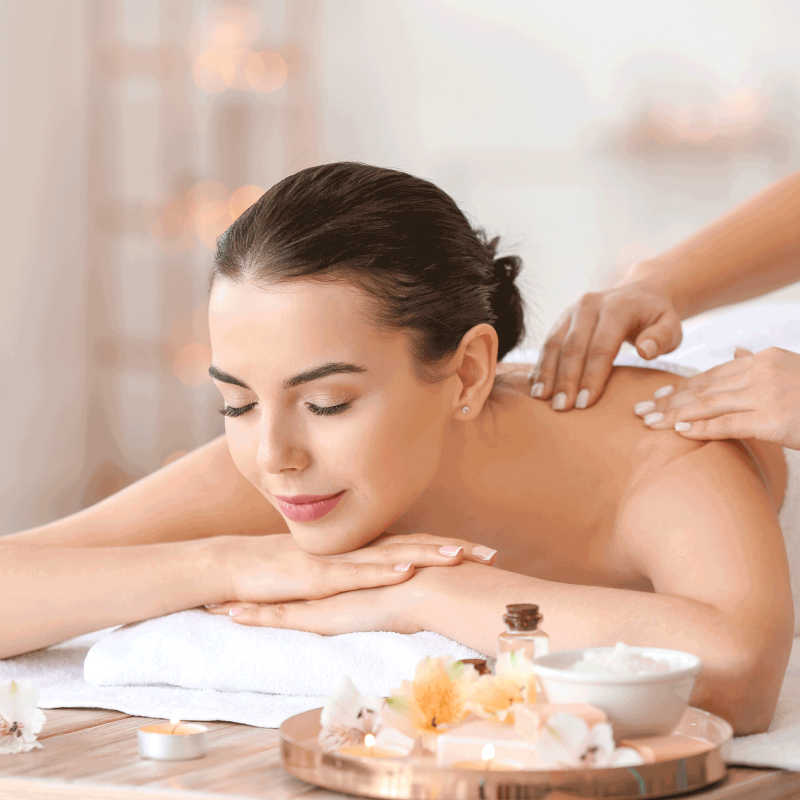 Beautiful young woman receiving massage in spa salon