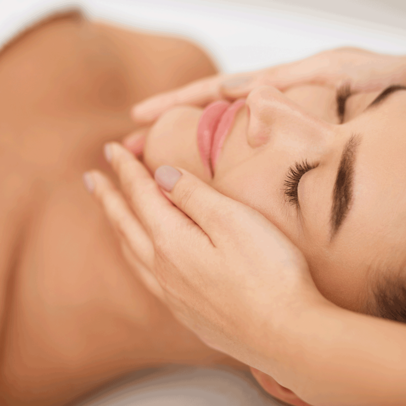 Woman getting face massage at beauty salon, closeup