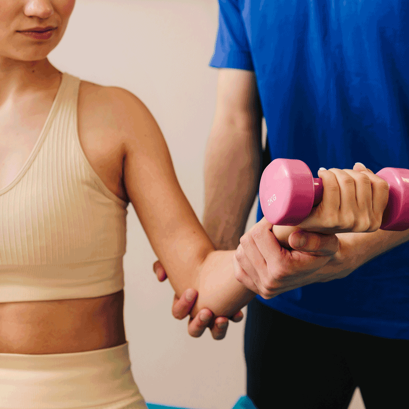 Therapist is helping patient to restore arm movement after illness. Doctor is helping with physiotherapy to restore body functioning. Effective PT to heal from injury.