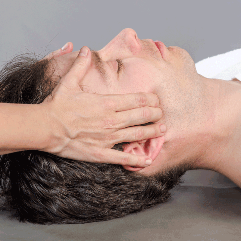 Chiropractor /physioterapist assessing the muscles on a jaw